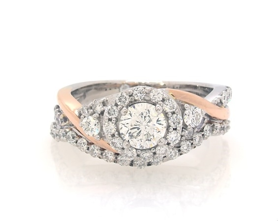 Previously Owned THE LEO Diamond Round-Cut Halo Twist Bridal Set 1-1/5 ct tw 14K Two-Tone Gold
